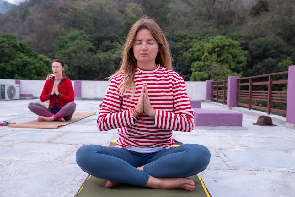 Woman practicing yoga outdoors in a tranquil mountain setting